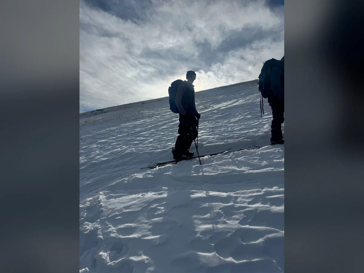 Skiers making their way across a snowy slope