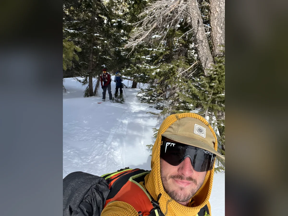 A skiing selfie on a snowy forest trail