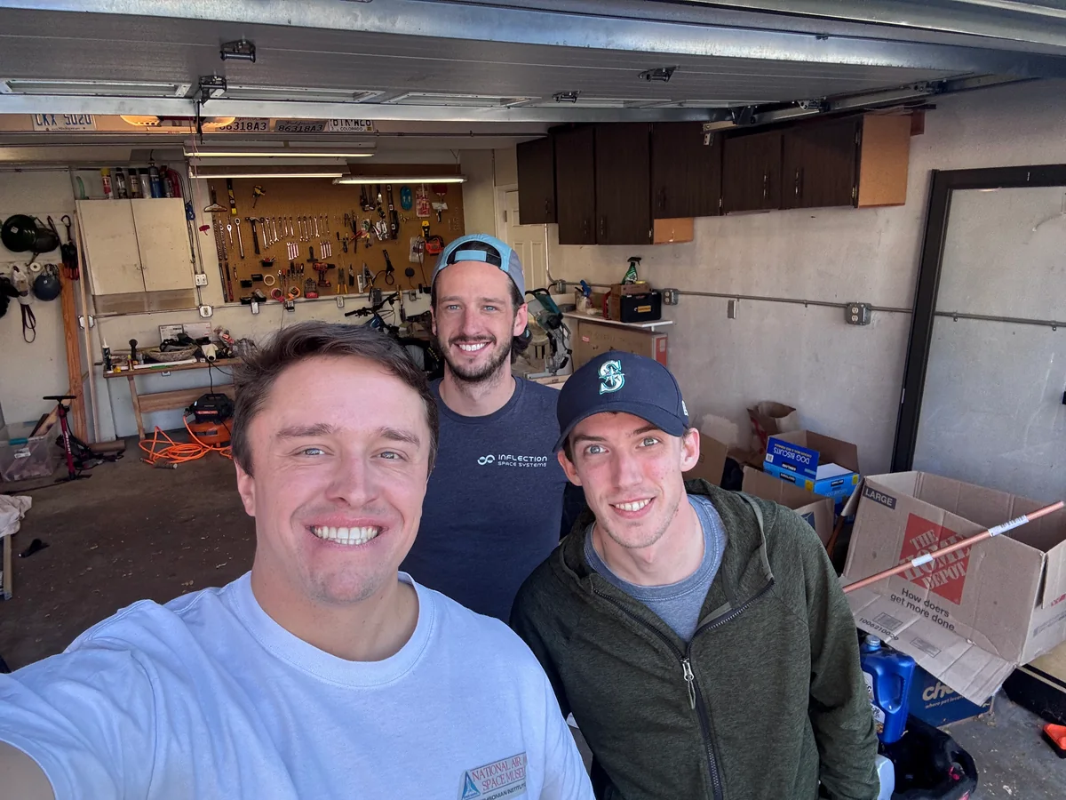 Three teammates taking a selfie in the workshop