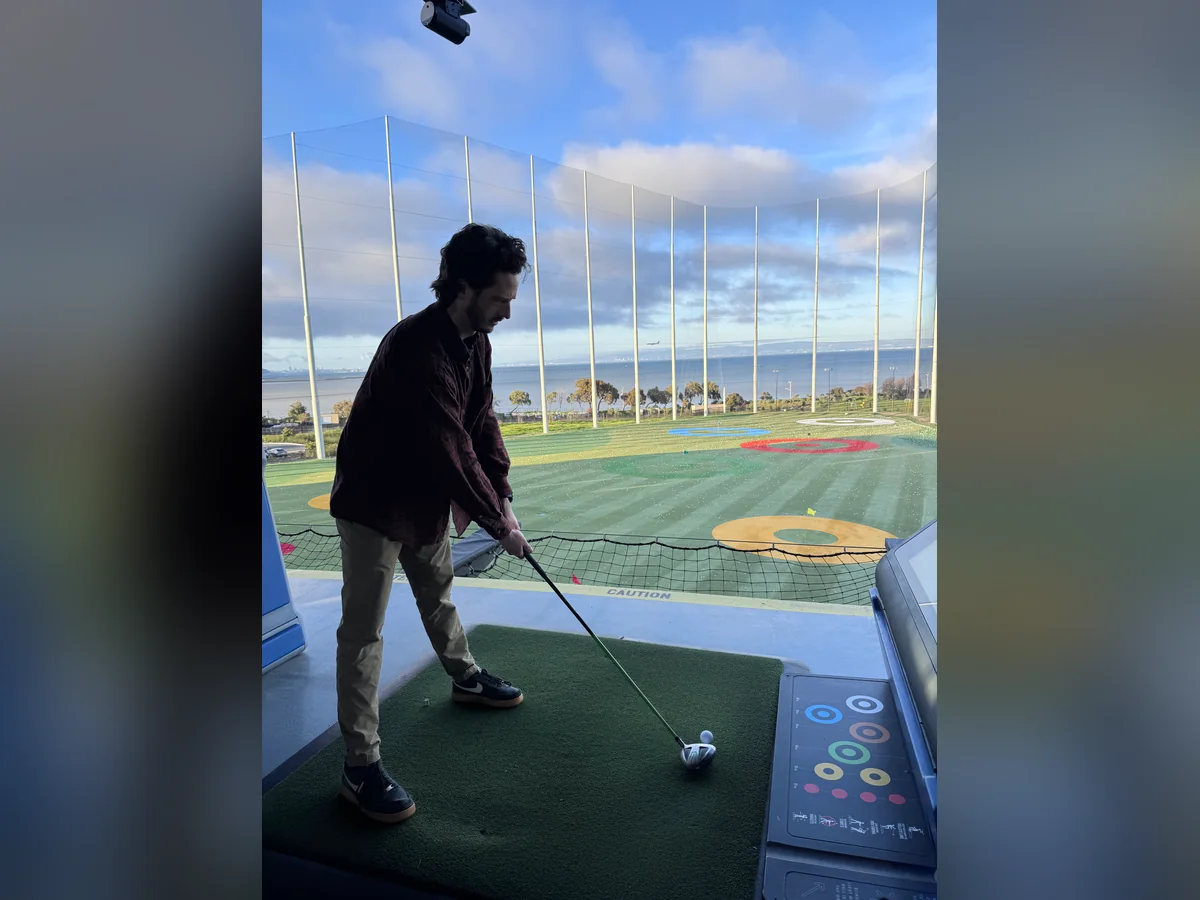 Practicing a golf swing at a driving range