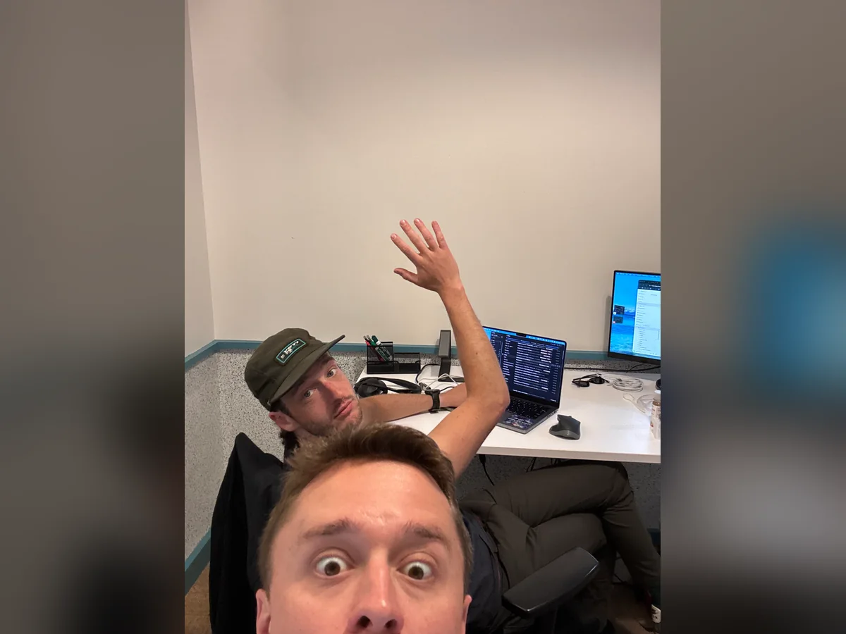 A playful selfie and wave from the office