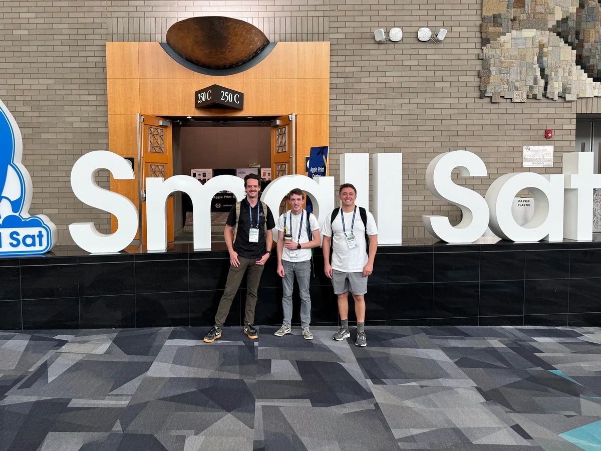 Three teammates at the SmallSat conference